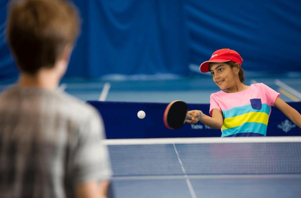 Image of two children playing table tennis