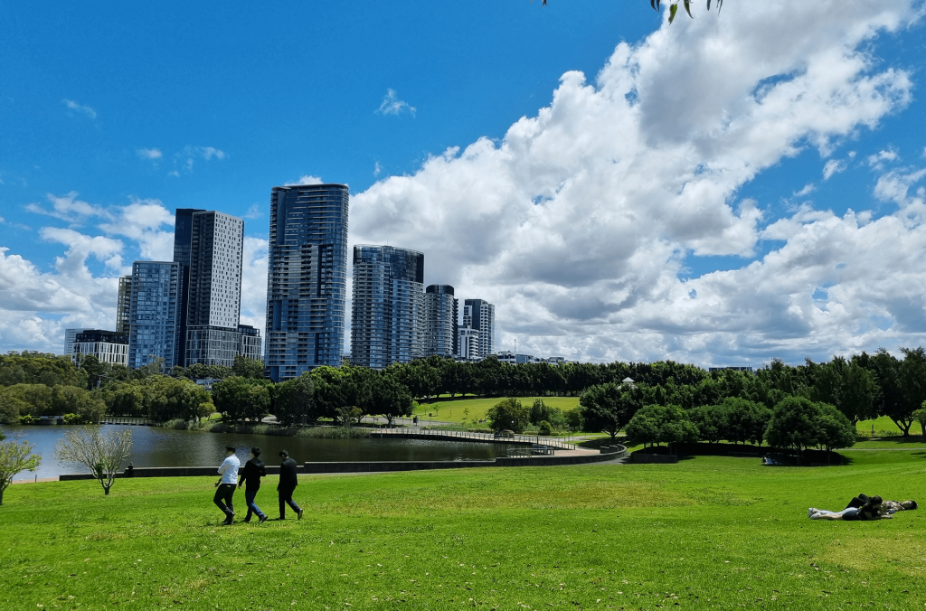 Group of people at Bicentennial Park with urban backdrop