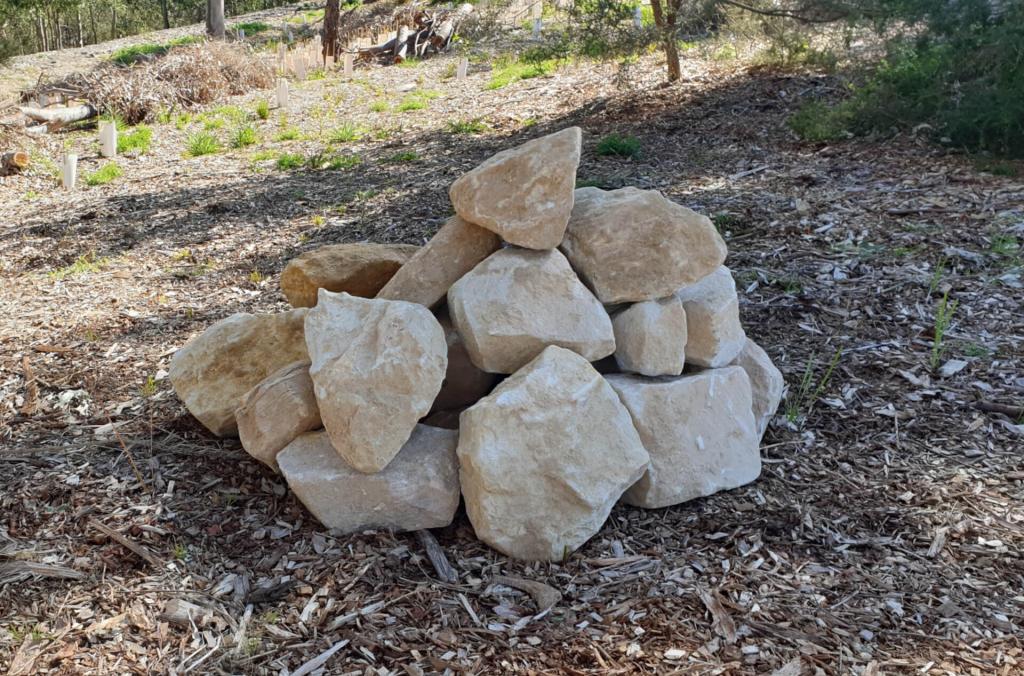 A stack of grey rocks on the ground